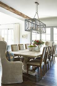 Rustic Cottage Dining Room Boast A Whitewashed Trestle Dining Table Seating Two Gray Linen Wing Cottage Dining Rooms Farmhouse Dining Room Dining Room Lighting