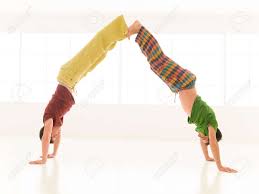 Try yoga with a partner and combine your abilities for a deeper practice together. Two Men Are Doing Yoga Partners In A Gym Stock Photo Picture And Royalty Free Image Image 25581974