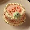 Instead of a colourful number three and big green frog, the boy's cake was decorated with a 'pathetic' smiley face and small '3' in green icing. 3