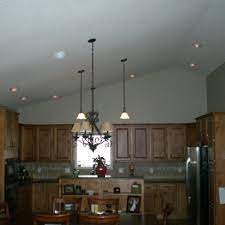 A recessed lighting fixture consists of a metal housing suspended between ceiling joists by an extension bar, or mounting frame. Can Light For Sloped Ceilings Vaulted Ceiling Kitchen Recessed Lighting Fixtures Vaulted Ceiling Lighting