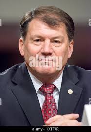North Dakota, USA. 30th March 2019. Denver Pioneers forward Colin Staub  (24), American International Yellow Jackets forward Luka Maver (25) and  American International Yellow Jackets forward Shawn McBride (29) race after  a