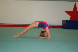 Learn how to safely and correctly perform a gymnastics bridge. Tips On How To Do A Bridge Stretch In Gymnastics To Build Core Muscles Gymnastics Stretches Gymnastics Bridge Gymnastics