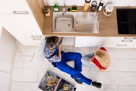 Remodeling a new kitchen is very exciting and should be a rewarding process, not a nightmare full of despair. High Angle View Of Male Worker Repairing Kitchen Sink Stock Photo C Andreypopov 7751543 Stockfresh