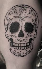 Couples can try matching skull candy tattoos and a cool idea would be to tie up two skulls along with pretty flowers just like this. Sugar Skull Tattoos Meanings Tattoo Designs Ideas