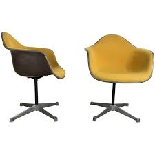 pair of charles and ray eames swivel padded arm shell chairs two tone shell chair ray eames charles ray eames