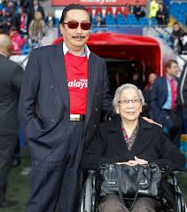 Vincent Tan's mother demonstrates what happens when a Bond villain's parent  intervenes