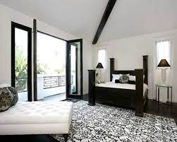 Black walls contrast starkly with a crisp white ceiling and white bedding. White Walls Black Trim Contemporary Design Black White Bedrooms White Bedroom Decor Yellow Bedroom Decor