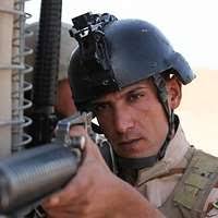 Pfc. Tyler Allen (background), a medic with Company