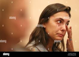 Jenna Glick wipes tears from her eyes as members of the Beth Sholom  synagogue in Miami Beach, Fla. gathered