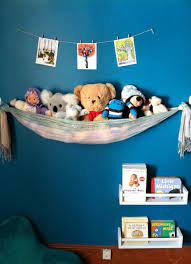 Make a corner animal zoo in a kid's bedroom using rounded corner shelves and clothesline ropes attach stuffed animals to a chain with clothespins, and hang them in a corner to get them out of the way 13 Ways To Store All Of The Kids Stuffed Animals