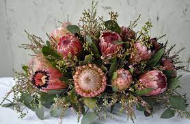 The Holiday Season Is In Full Swing And As Thanksgiving Approaches More Emphasis Is Pla Flower Vase Arrangements Australian Native Flowers Protea Centerpiece