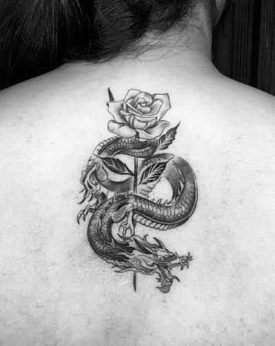 The meaning of the dragon and a rose tattoo is fiery passion. Dragons are known to be intense in the way that they are powerful and strong. When we add a rose