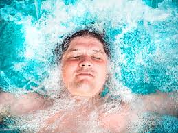 Happy Man Relaxing In The Hot Tub And Closing His Eyes Caucasian Boy  Resting In A Pool Lies In Water View From Above Swimming Guy In A Pool With  Blue Water Bathing