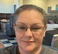 A mum claims she's been left nursing a splitting headache after her 'brown'  sofa turned out to be 'shiny Tin Man silver'