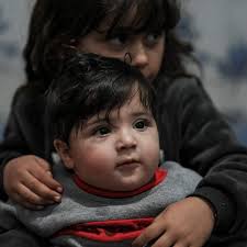 Joy as baby given to US soldier during Afghan withdrawal is reunited with  relatives