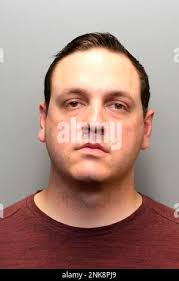 Fort Collins, Colo. Police officer Neal Hisam holds up a head board with  ropes attached that he had collected as evidence during the trial of William  Hunsaker at the Larimer County Justice