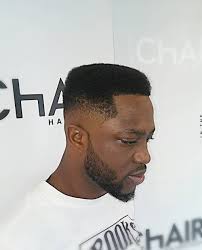 Barber trim hair with clipper on young unshaven black man in barbershop studio. 28 Fresh Hairstyles Haircuts For Black Men In 2021
