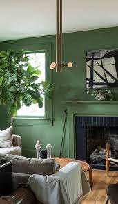 Vintage Green Living Room With Midcentury Inspired Wood Pendant And Comfy Couches Living Room Green Stylish Living Room Living Room Lighting