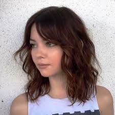 And it still offers much freedom for experiments, one of which is adding a fringe. Medium Length Brunette Wavy Haircut Hairs London
