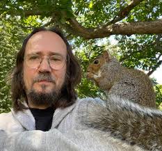 Squirrel's behavior in the backyard with big trees