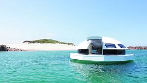 Brown wooden house in body of water under blue sky, maldives, maldives. This Solar Powered Floating Pod Lets You Live Like A Bond Villain Robb Report