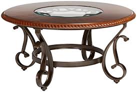 Furniture of america pelletoni 2 piece wood coffee table set. Ashley Furniture Signature Design Gambrey Traditional Round Cocktail Table With Glass Inlay Reddish Brown Buy Online In Bahamas At Bahamas Desertcart Com Productid 49624728