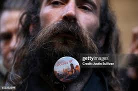 An Occupy Wall Street protestor wears a button