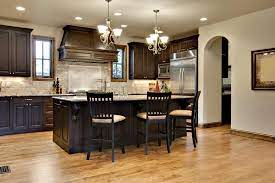 Cherry wood cabinets go well with many different stains of hardwood flooring. Kitchen Flooring Ideas The Top 25 Trends Of The Year Dark Kitchen Cabinets With Light Hardwood Floors