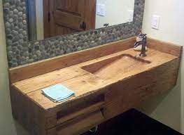 Bathroom sink with a durable wooden construction and rustic stylization. Hamilton Construction Log Sink Wood Sink Rustic Bathroom Sinks Modern Bathroom Sink