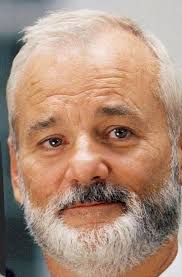 What is the meaning of the man's gesture in the background of the  Ghostbusters news report scene?