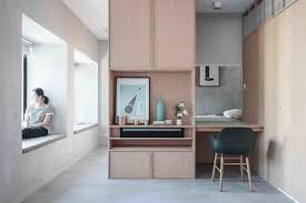 The office area makes smart use of vertical space, from the desk and wall shelving to the adjacent bookcase. How To Work From Home In A Tiny Apartment Dwell