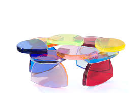 Colored glass is layered in a design that is reminiscent of a quilt pattern. Acrylic Coffee Table Bon Bon Marco Pettinari