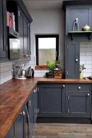 First, let's talk about illumination—three vintage farmhouse pendant lights in green function as task lighting. Butcher Block Countertops Paired With Dark Blue Painted Cabinets American Kitchen Design Kitchen Design Kitchen Cabinets Makeover