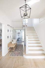 Entry With High Ceilings Light Oak Floors Pure White Walls Circa Lighting Darlana Lantern Rattan Bench Turkish Runn Light Oak Floors White Oak Floors Home