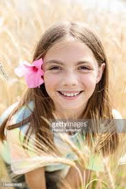 Portrait Of Girl In Wheat Field Smiling High-Res Stock Photo