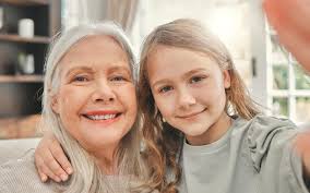 Home selfie and grandmother with girl smile and profile picture with  happiness bonding together and relax house granny and grandchild in living  room for joy post social media and love portrait |