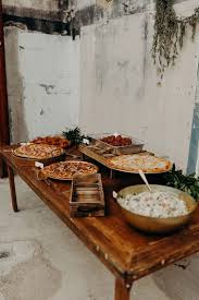 A Vintage Rustic Pizza Bar With Lots Of Pizzas On Stands And With Marks Plus Greenery And Salad In A Bo In 2020 Wedding Food Bars Reception Food Wedding Reception Food