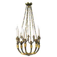 An Italian Neoclassical Parcel Gilt Ebonized And Carved Twelve Light Chandelier Possibly Austrian Ci Antique Lighting Antique Chandelier Chandelier Lighting