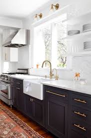 (featured here) painting just a section of the cabinets, such as a range hood or kitchen hutch, adds interest to a lighter colored kitchen. Modern Kitchen With Dark Gray Cabinents Vintage Runner And Marble Countertops Kitchen Decor Inspiration Kitchen Design Kitchen Inspirations