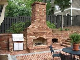 An Outdoor Fireplace With Built In Grill And Wood Storage Backyard Fireplace Outdoor Remodel Outdoor Fireplace