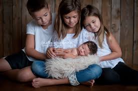 Brand New Baby Girl Cooper Photographed In Studio With Mother Siblings And Fire Fighter Father Newborn Photography Girl Newborn Pictures New Baby Products