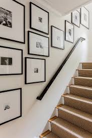 Gallery Wall Art Staggered Along A Staircase Wall In Black Frames Showcasing Black And White Lifestyle Photos Staircase Wall Decor Gallery Wall Frames On Wall