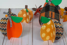 Glue things to the pumpkin. Easy Paper Pumpkin Craft With Cricut Color Me Crafty