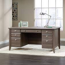 The drawers offer a place to store pens, pencils or whatever supplies that you like to keep close at hand. Shoal Creek Executive Desk 418656 Sauder Sauder Woodworking