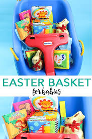 This baby easter basket is full of helpful goodies for a new baby and moms! Create An Easter Basket For A Baby With A Swing And Some Toys And Of Course A Lindt Gold Bunny Or Baby Easter Basket Unique Easter Baskets Easter Gift Baskets