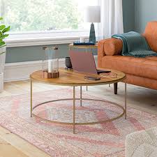 The top lifts up and forward to create a work or dining surface at just the right height, as well as open shelves for additional storage and display. International Lux Round Coffee Table Sindoori Mango 428214 Sauder Sauder Woodworking