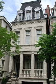 Stunning french home exterior accented with mansard roof, red brick dual chimneys and black matte door. French Roof French Home Exterior Mc Construction Group
