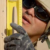 U.S. Army Sgt. Richard Jordan, left, treats Pfc. Daniel