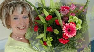 Joy scoops a bouquet for her tireless work