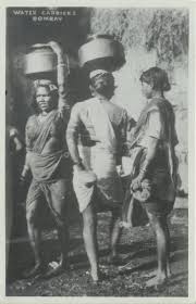 Women Carrying Water in Metal Pots on ...